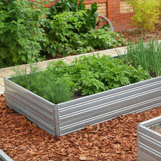 Metal Planta Garden Bed - 2 Tiers with green plants in a garden setting