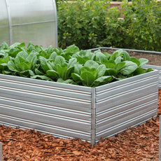 Metal Planta Garden Bed - 3 Tiers with green plants in a garden setting