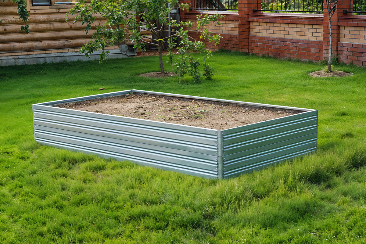 Metal raised Planta Garden Bed - 2 Tiers on grass with a wooden cabin in the background