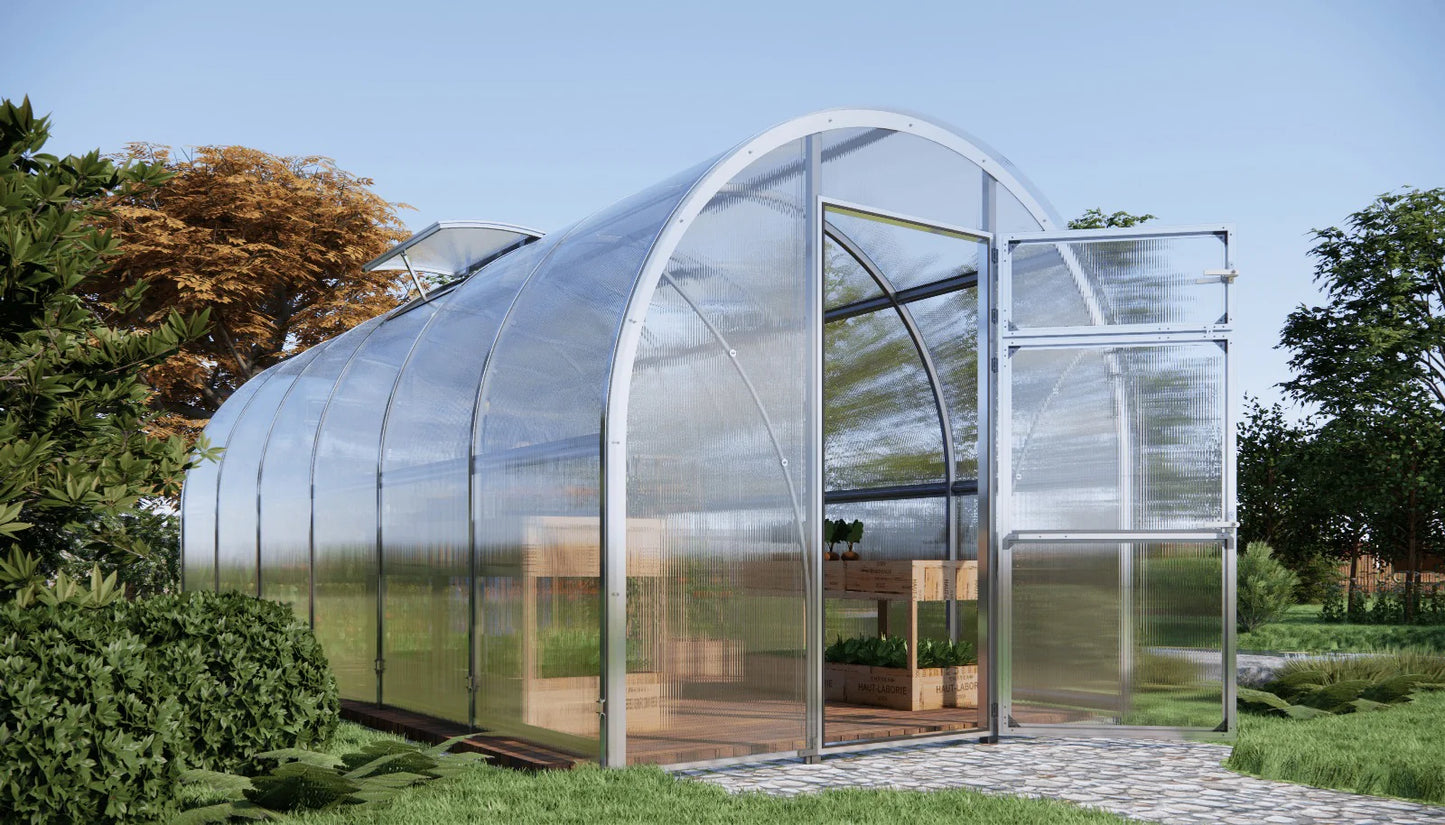 Modern Sigma 250 (Gen III) greenhouse with transparent walls and a metal frame, surrounded by greenery.