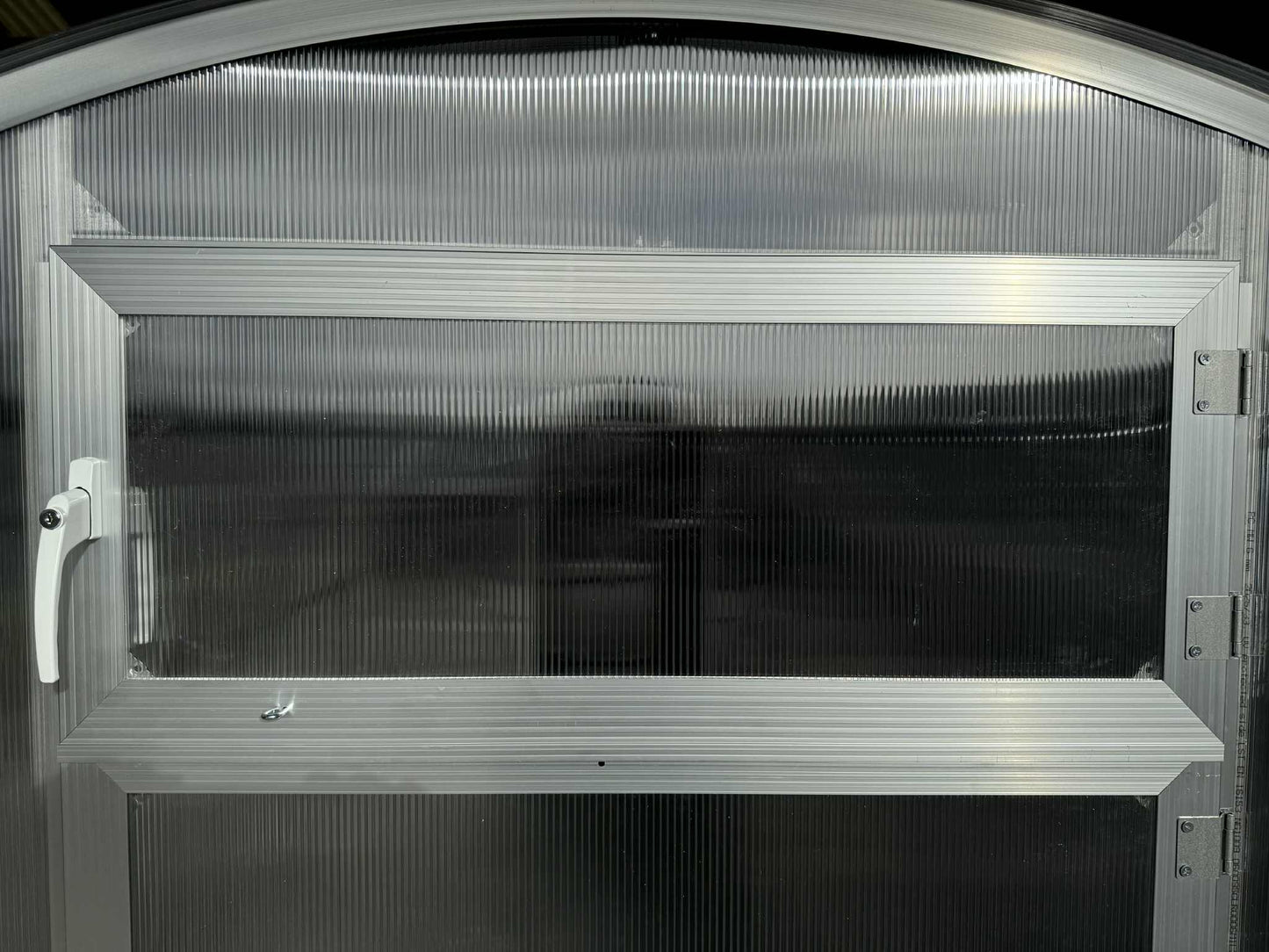 Metallic door with a reflective surface, of a  Sigma 300 (Gen III) greenhouse.